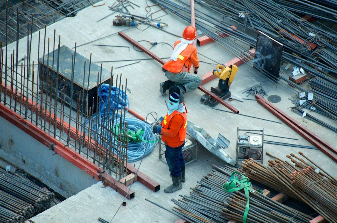 Operatives in hi-vis working on a live construction site