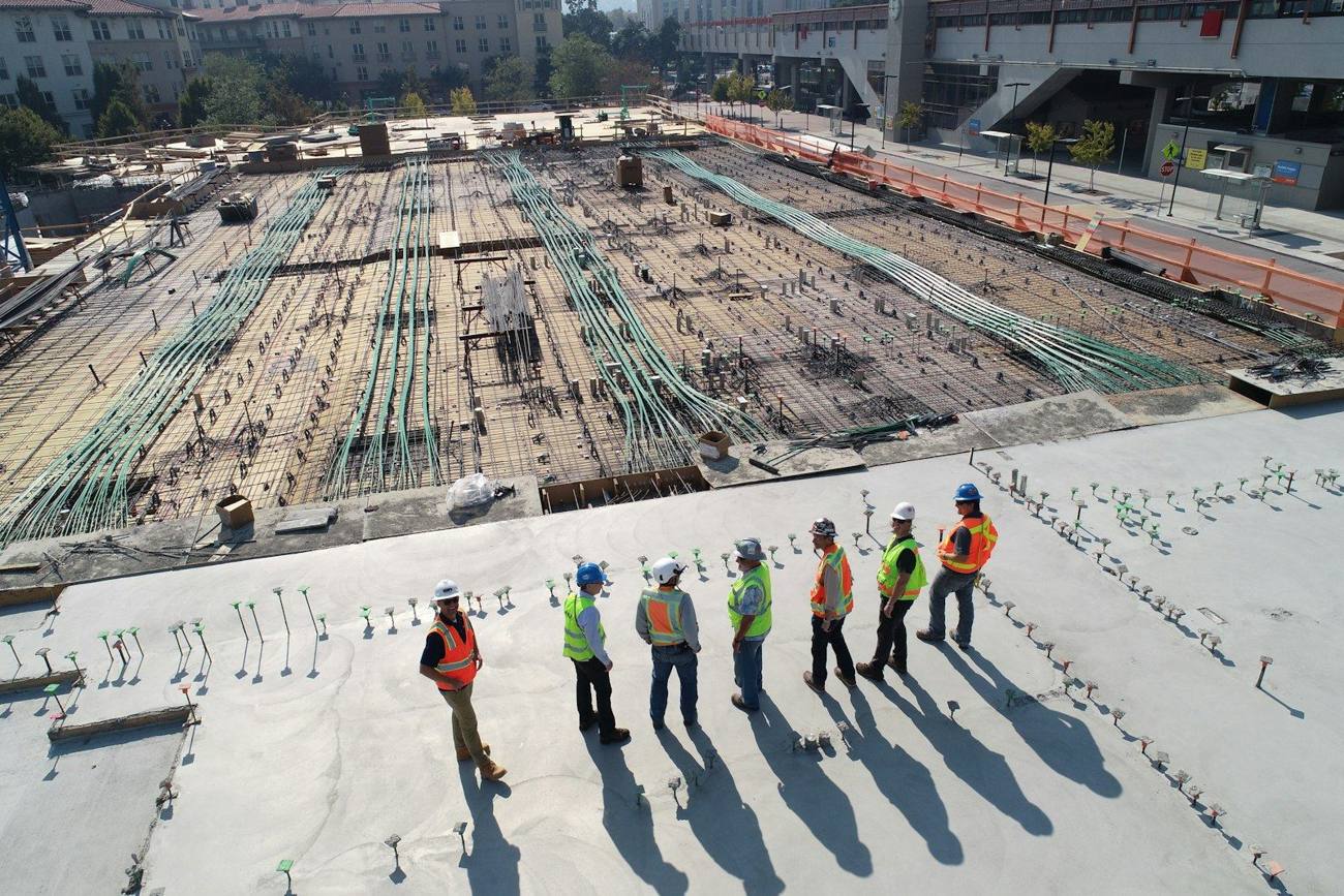 Site team in hi-vis reviewing works on a live project